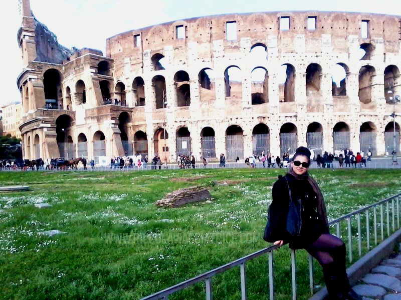 person sitting near the colosseum